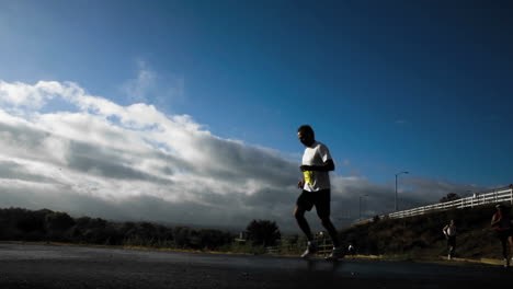 Runners-passing-along-a-jogging-trail--time-lapse