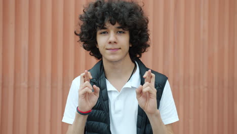teenager crossing fingers