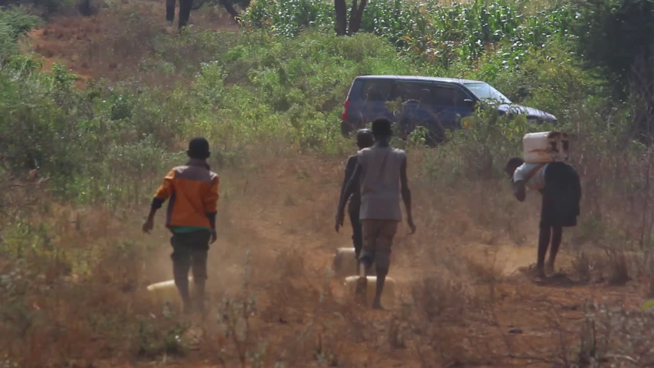 water desert hopeless filth water scarcity. African children looking at water miles away. clean child African water pump .