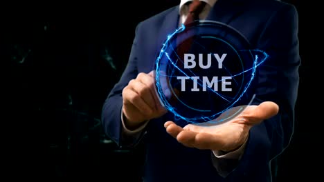 businessman shows concept hologram buy time on his hand