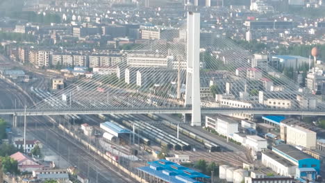 bird's light city of multi-level junction road lands with moving cars traffic of modern highway with overpass bridge high speed train at countryside