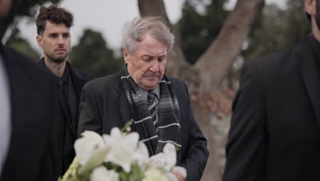 funeral, death and senior man carry coffin