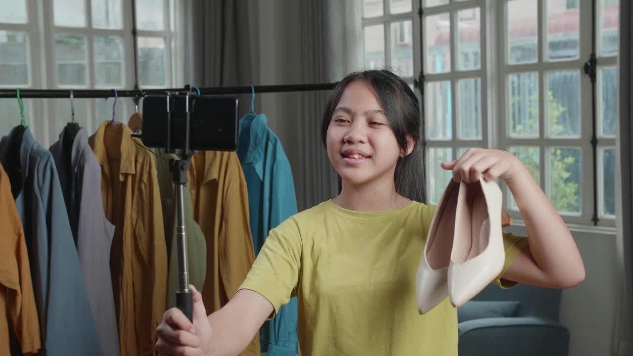Asian Young Girl Online Seller Recommending Kitten Heels And Recording Video By Mobile Phone While Selling Shoes At Home