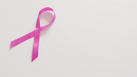 Video-of-pink-breast-cancer-ribbon-on-white-background