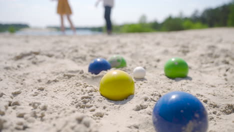 Close-up-view-of-some-colorful-petanque-balls-on-the-beach-on-a-sunny-day