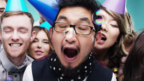 Multi-racial-group-of-happy-people-dancing-with-bubbles-slow-motion-party-photo-booth