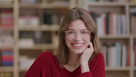 Beautiful-young-woman-wearing-glasses-looks-to-camera-and-smiles