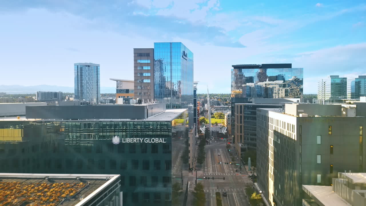 Denver, USA, 24 August 2025: Footage over the street among the glass high-rises. Going up above the cityscape of Denver, Colorado, USA