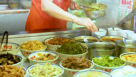 vendor preparing dishes at a food stall