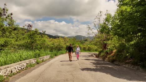 couple hiking on a mountain road