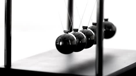 newtons cradle in motion on white background