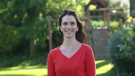 Woman-smiling-in-a-sunny-garden