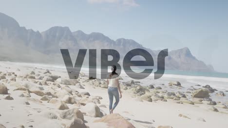 animation of the word vibes in black over woman walking on beach