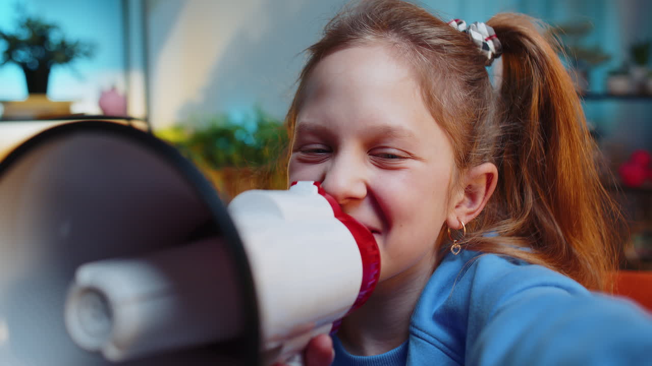 Teen child girl kid talking with megaphone proclaiming news loudly announcing advertisement
