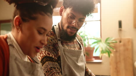 couple cooking together in kitchen