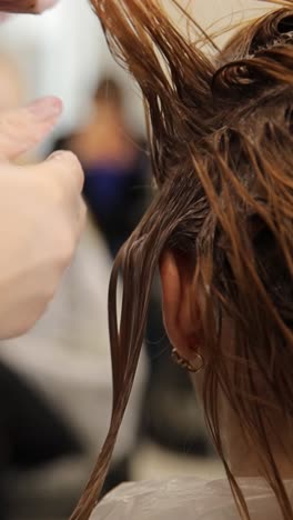 creative hair styling techniques for a girl in a beauty salon, close-up