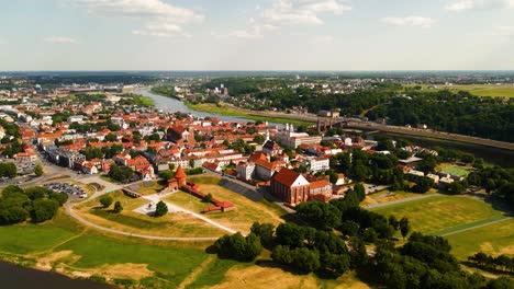 aerial-shot-of-Kaunas-old-town-with-Kaunas-castle,-churches-and-other-old-red-roof-houses-in-Kaunas,-Lithuania-on-a-sunny-summer-day,-there-is-Nemunas-and-Neris-rivers-in-the-shot