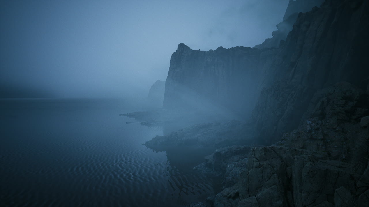 Foggy coastline at dusk with dramatic cliffs and tranquil water