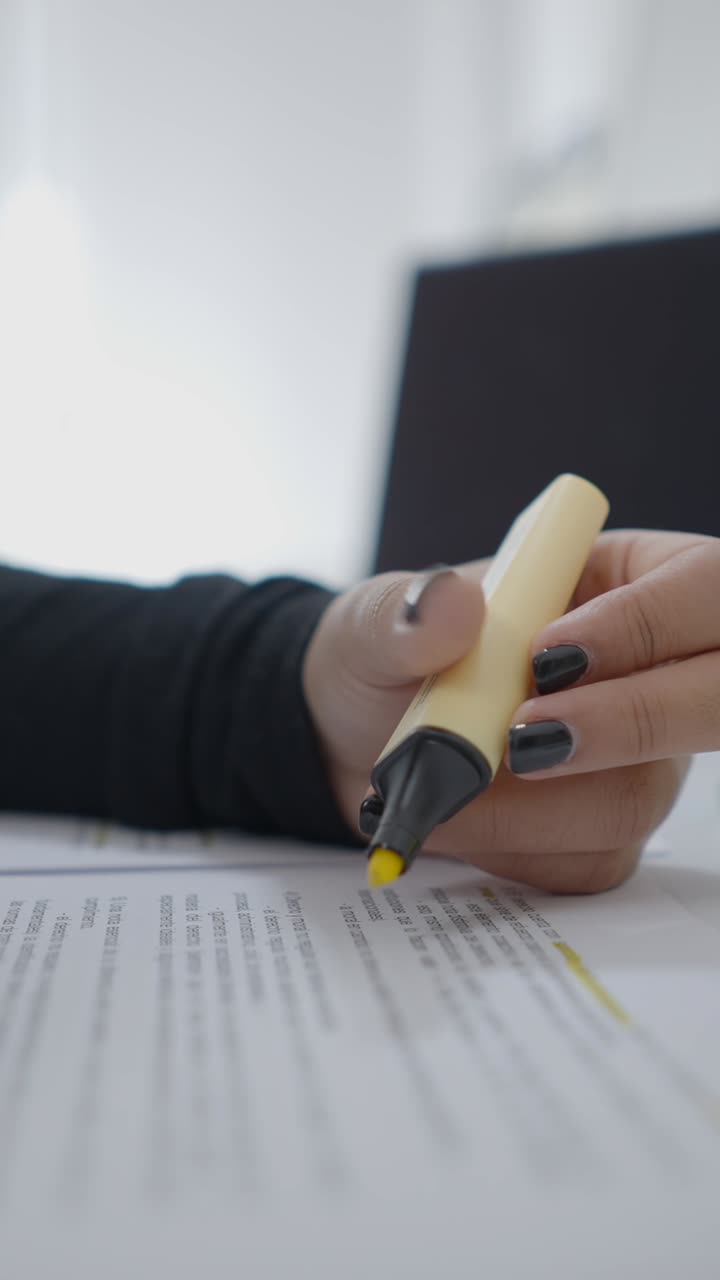 Person Highlighting Text on a Document