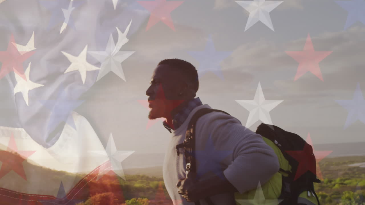animación de la bandera estadounidense sobre un hombre afroamericano caminando por las montañas
