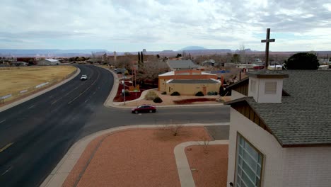 aerial passing cross atop church in page arizona