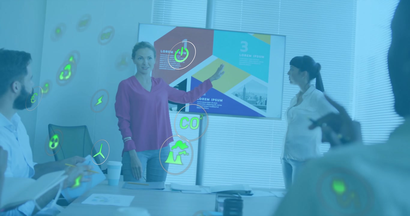 Presenter gesturing toward chart, co presenter joining talk on green metrics with floating icons