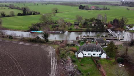 baits bite lock river cam cambridgeshire uk aerial drone footage , narrow boats waiting to pass through