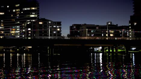 cityscape with illuminated buildings and reflections on water