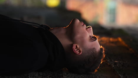 young man looking up to the sky, side lit by orange rim light, beautiful cinematic lighting, close up, vertical