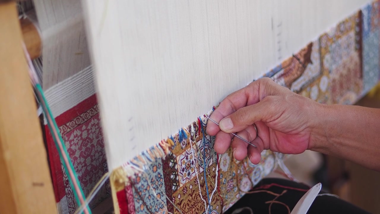 Artisan Hand Weaving an Intricate Traditional Carpet
