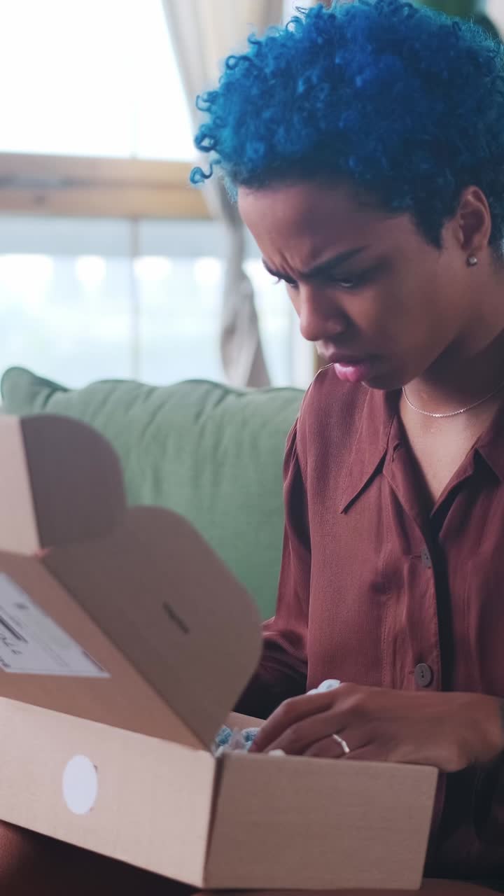 Young frustrated ethnic african american woman gets upset after unboxing parcels