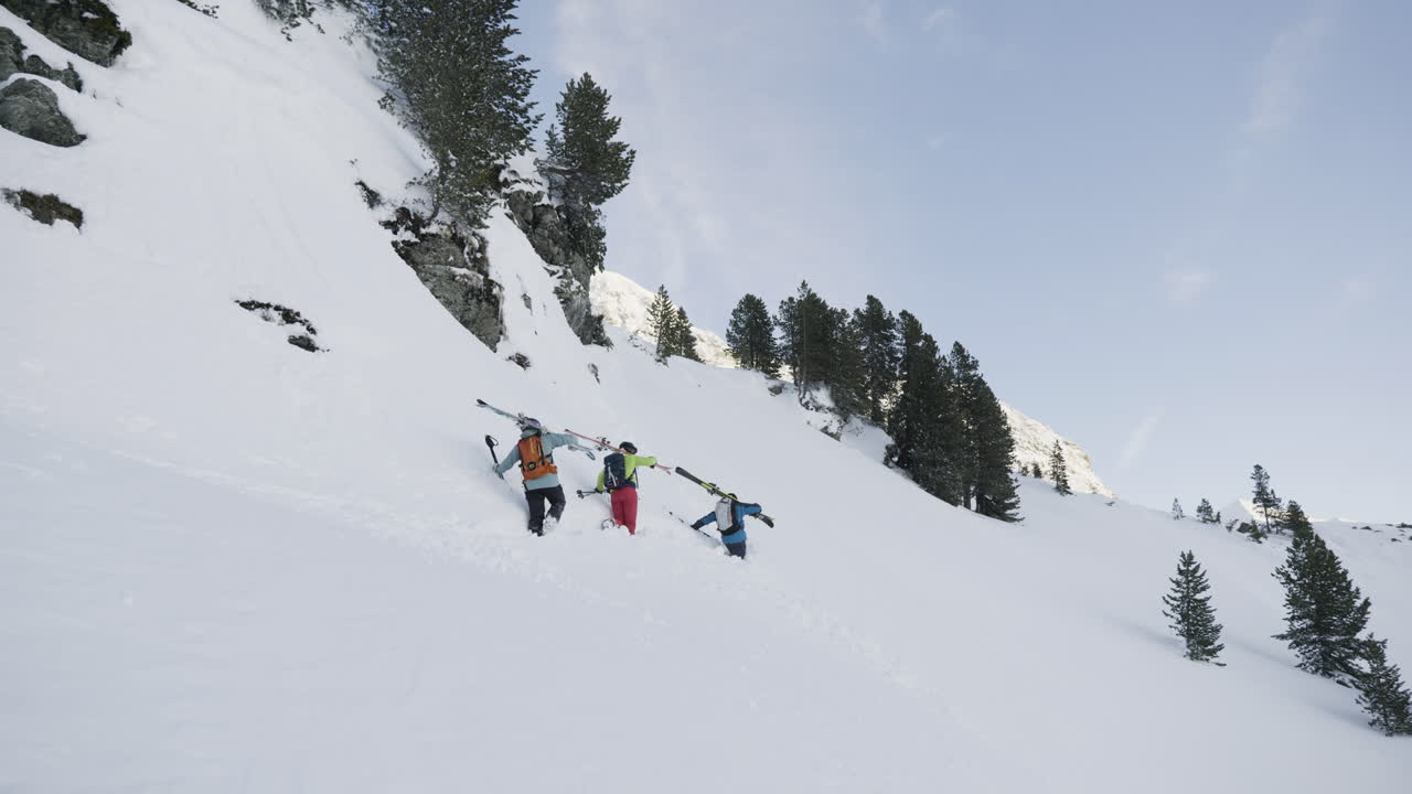 Ski Tourers Ascending a Snowy Mountain Slope