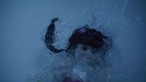 a vintage doll submerged in water