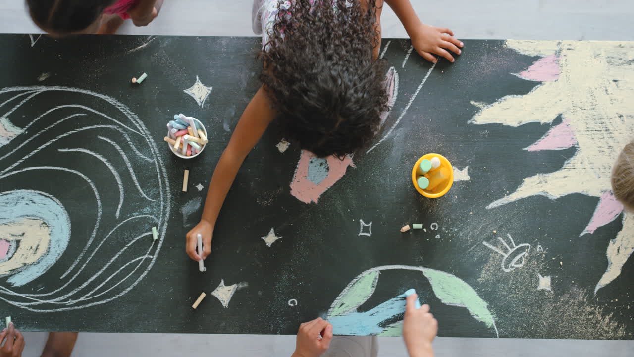 Children Drawing on a Blackboard with Chalk