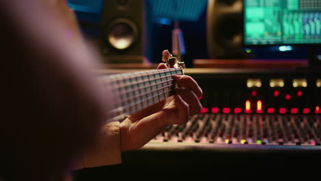 skilled artist singing on his guitar and recording tunes for a future song