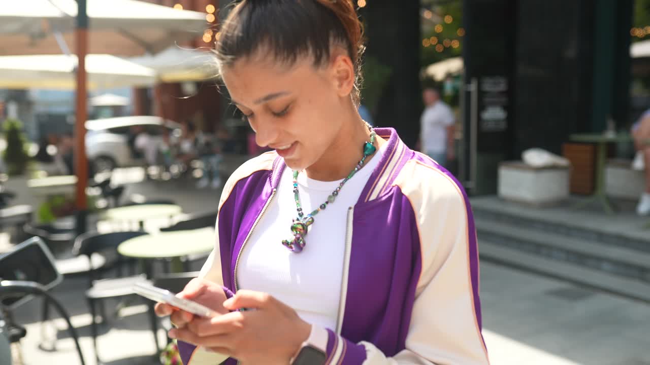 Young Woman Texting on Smartphone Outdoors
