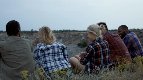 friends relaxing on cliff and having fun