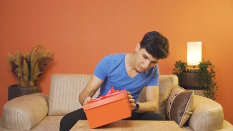 happy and joyful man opening gift package.