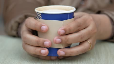 woman holding a coffee cup