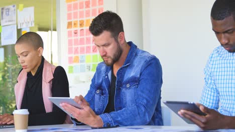 Mixed-race-business-colleagues-working-on-digital-tablet-in-modern-office-4k