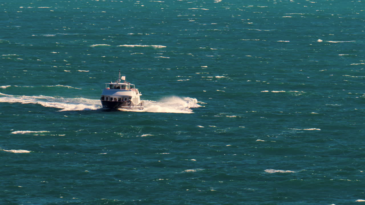 Nice, France - March 17, 2025: View of a boat moving on the blue sea in daylight