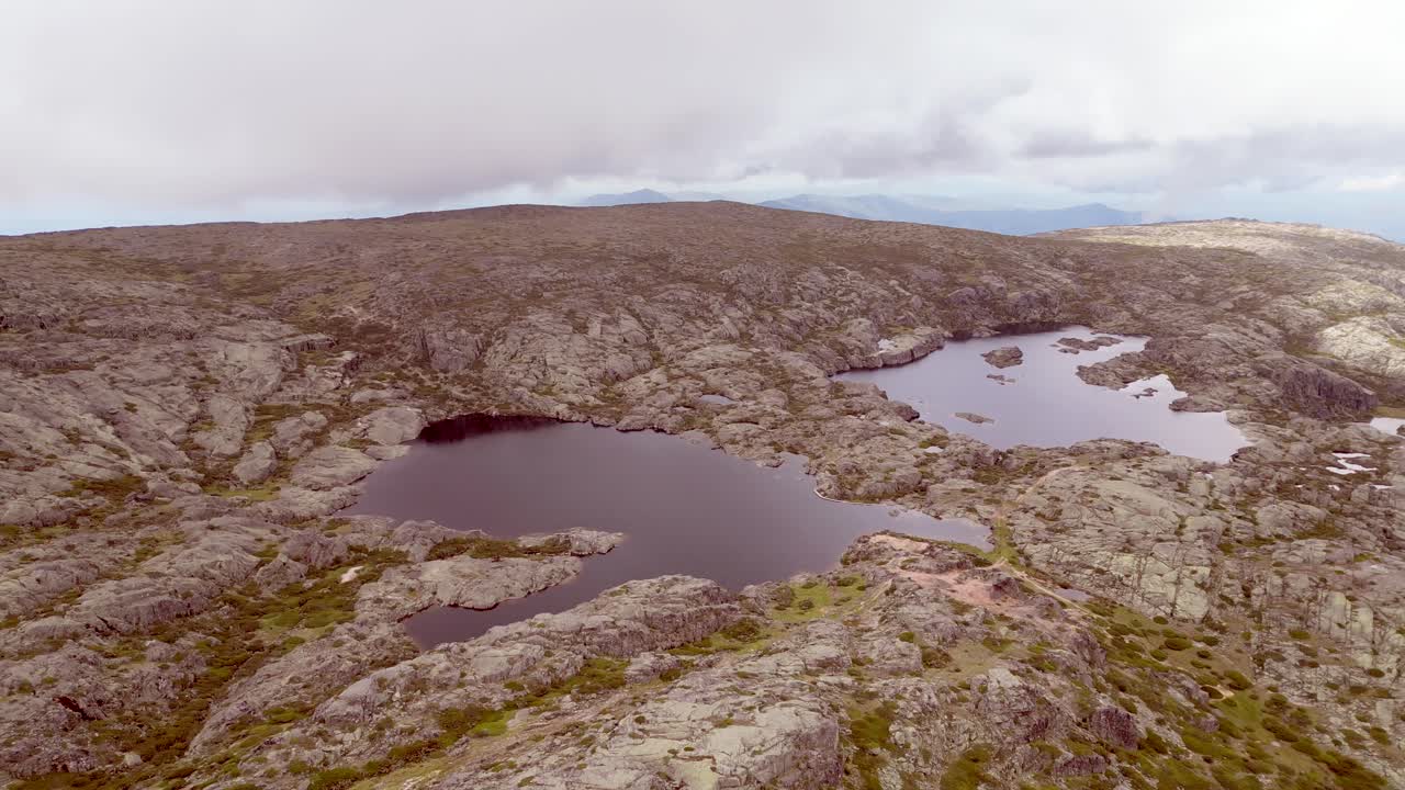 A broad landscape perspective showcasing the formation of a lake within Portugal's Serra de Estrella