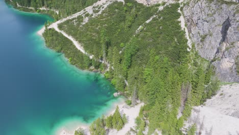 White-sand-turquoise-wilderness-lands-of-Pragser-Wildsee-Italy-aerial