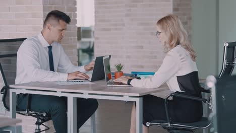 co workers in the office typing on computers