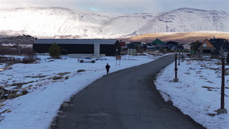 winding road through snowy mountain valley with a runner under sporting activity, caviahue, caviahue-copahue, neuquén, argentina