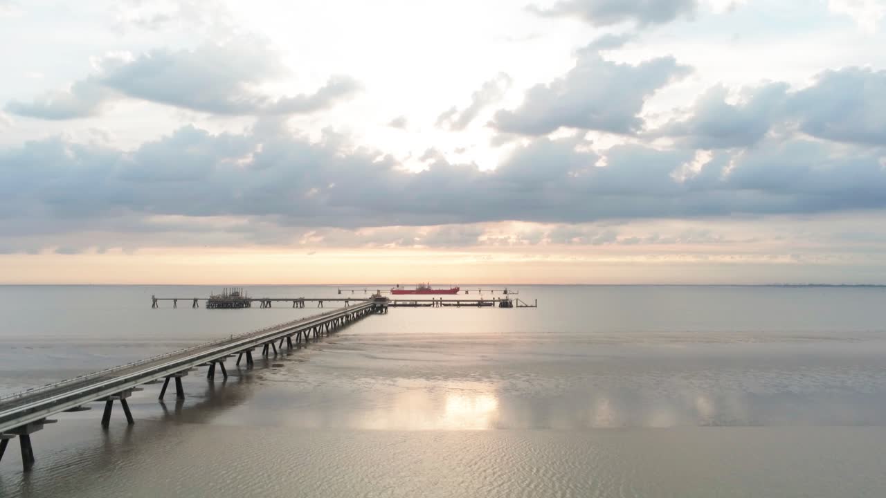 Aerial View of Vehicle Moving on Oil Pier Bridge Above Shallow Water of North Sea, Germany