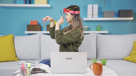 Funny-young-girl-study-at-home-cheerful-and-fun.