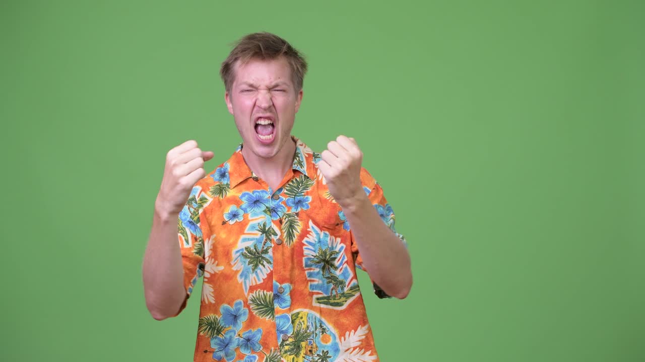 Young handsome tourist man looking excited