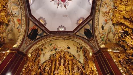 ornate church interior with golden altar and ceiling paintings