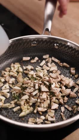 cooking sliced mushrooms in a pan